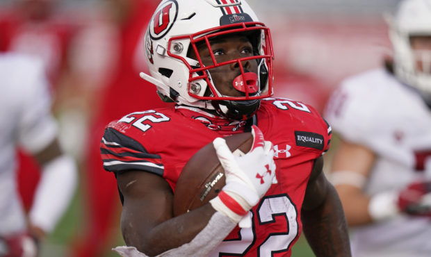 FILE - In this Dec. 19, 2020, file photo, Utah running back Ty Jordan (22) scores against Washingto...