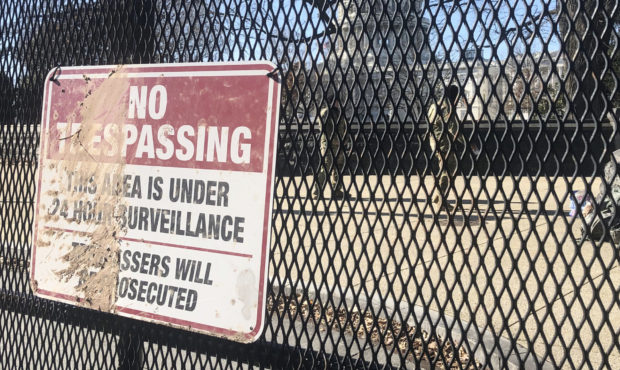 Members of the National Guard stand inside anti-scaling fencing that surrounds the Capitol complex,...
