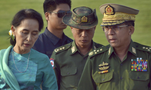 FILE - In this May 6, 2016, file photo, Aung San Suu Kyi, left, Myanmar's foreign minister, walks w...