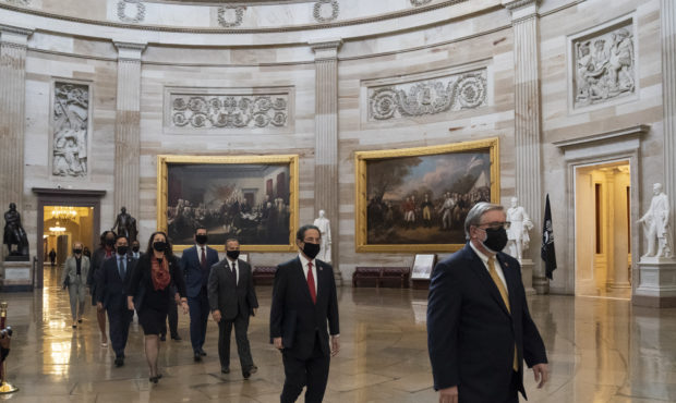 Acting Sergeant at Arms Timothy Blodgett, right, leads Rep. Jamie Raskin, D-Md., second from right,...