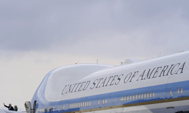 President Joe Biden waves as he and first lady Jill Biden board Air Force One at Ellington Field Jo...
