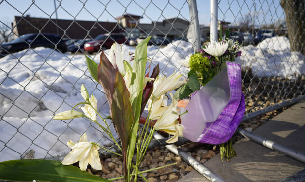 A small memorial stands along a makeshift fence put up around the parking lot outside a King Sooper...