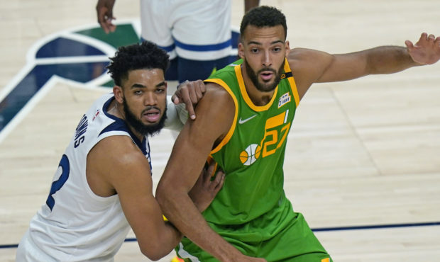 Minnesota Timberwolves center Karl-Anthony Towns, left, guards Utah Jazz center Rudy Gobert (27) in...