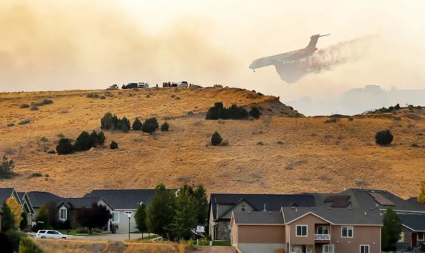 (A heavy tanker begins a retardant drop as crews respond to a fire burning near Goshen and Santaqui...