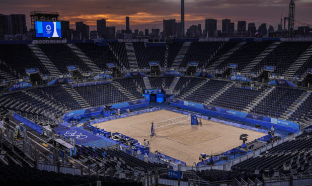 The sun sets during a break of beach volleyball at the 2020 Summer Olympics in Shiokaze Park, Tokyo...
