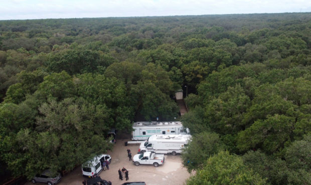 In this photo provided by North Port Police Department, law enforcement officials conduct a search ...