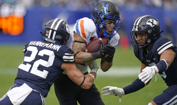 BYU defensive back Ammon Hannemann (22) tackles Boise State wide receiver Khalil Shakir, center, in...