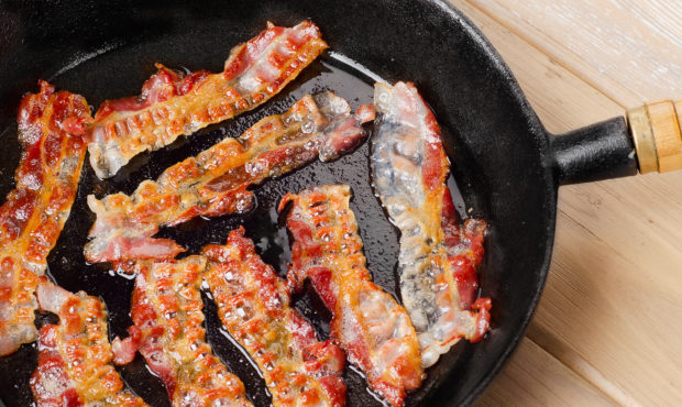 Cooked bacon rashers on a skillet. Selective focus...
