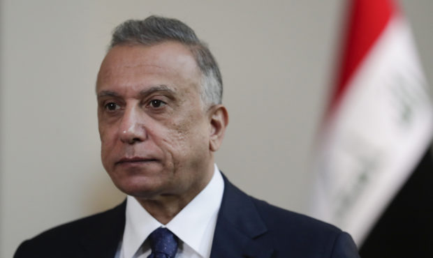 FILE - Iraqi Prime Minister Mustafa al-Kadhimi poses in his office during an interview with The Ass...