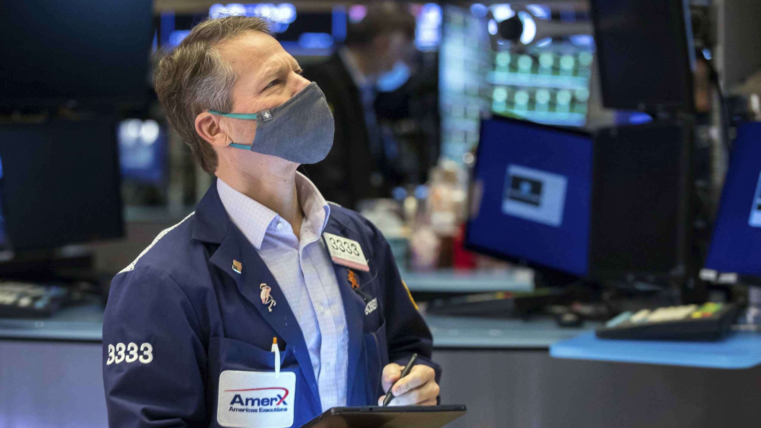 In this photo provided by the New York Stock Exchange, trader Robert Charmak works on the floor, Mo...