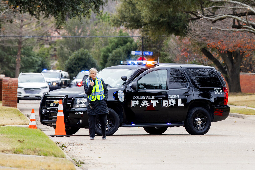Law enforcement officials block a residential street near Congregation Beth Israel synagogue where ...