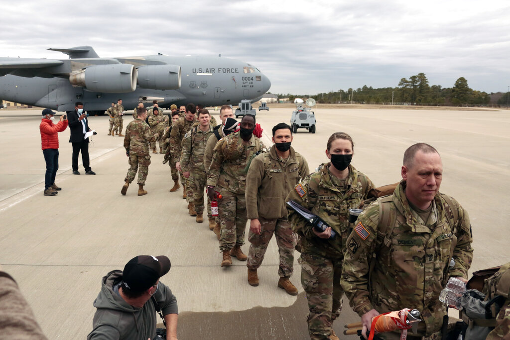 U.S. Army soldiers from the 18th Airborne Division board a C-17 aircraft as they deploy to Europe, ...