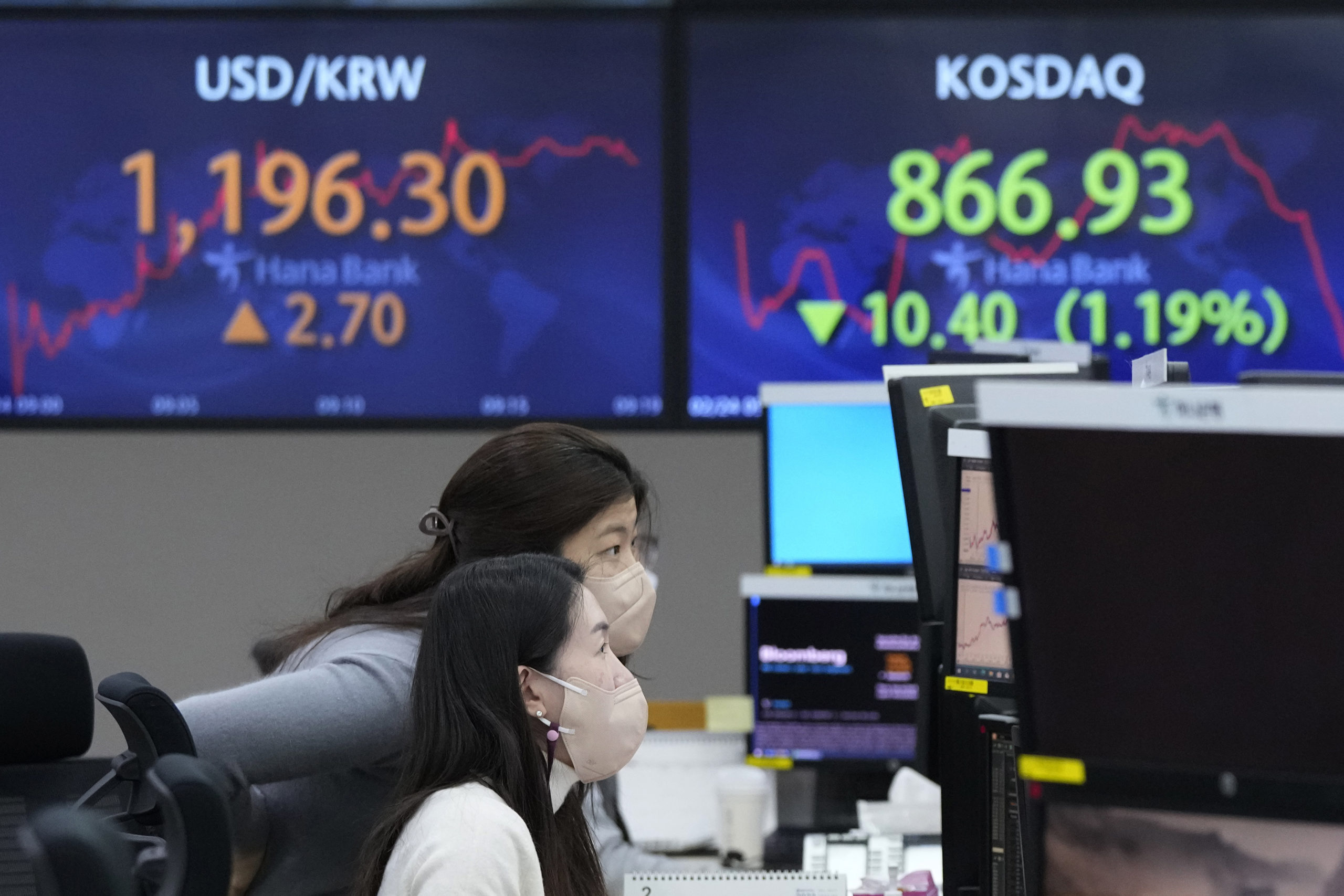 Currency traders watch monitors at the foreign exchange dealing room of the KEB Hana Bank headquart...