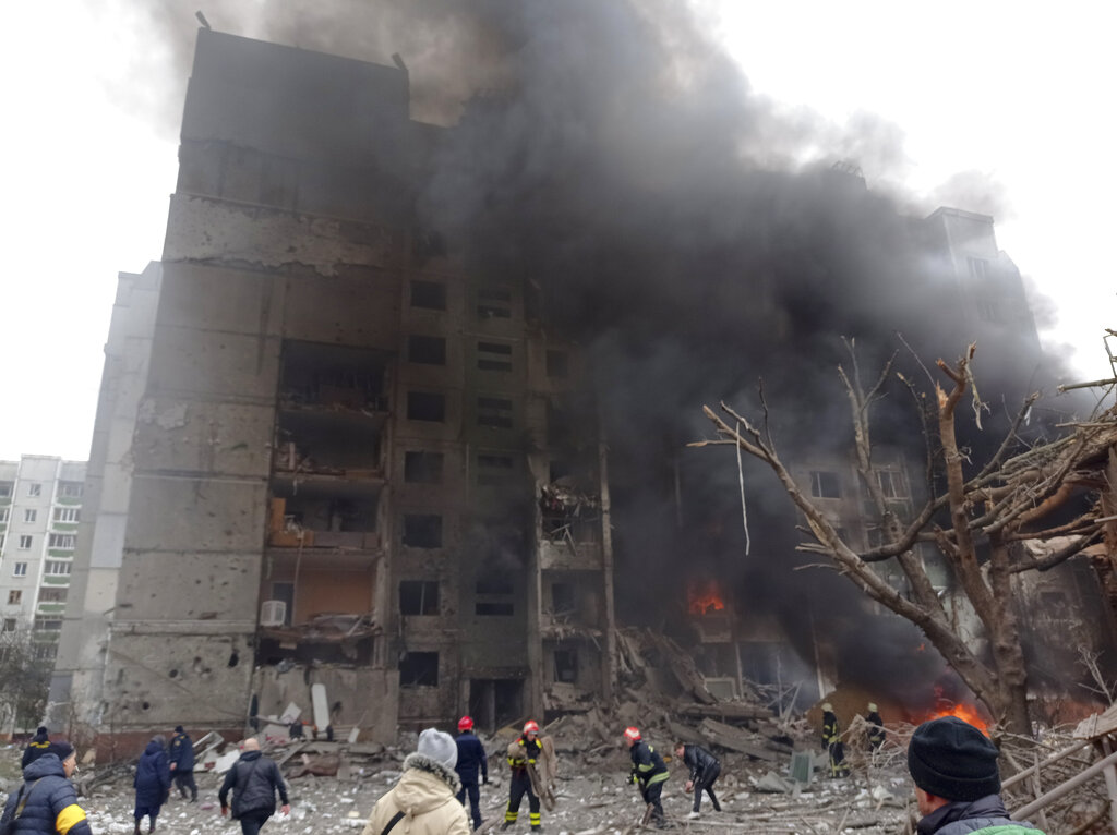 Firefighters work to extinguish a fire at a damaged city center after Russian air raid in Chernigiv...