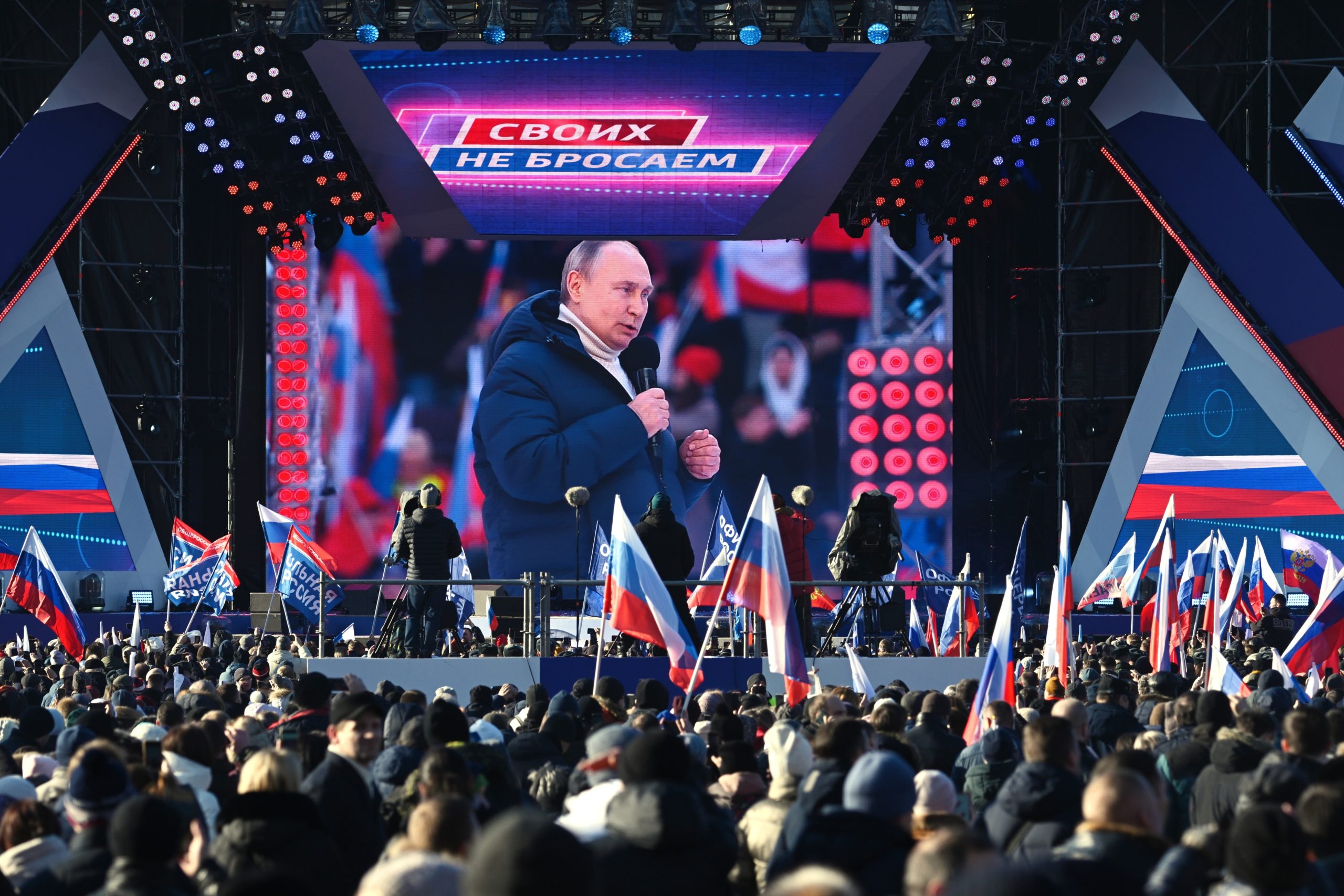Russian President Vladimir Putin seen on the big screen as he delivers his speech at the concert ma...