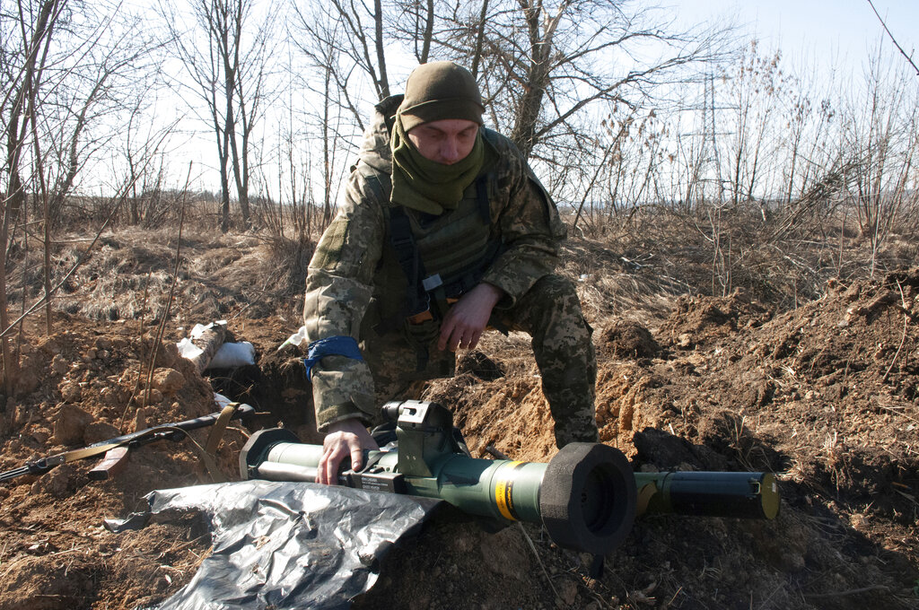 A Ukrainian serviceman guards his position in Kharkiv outskirts, Ukraine, Wednesday, March 23, 2022...