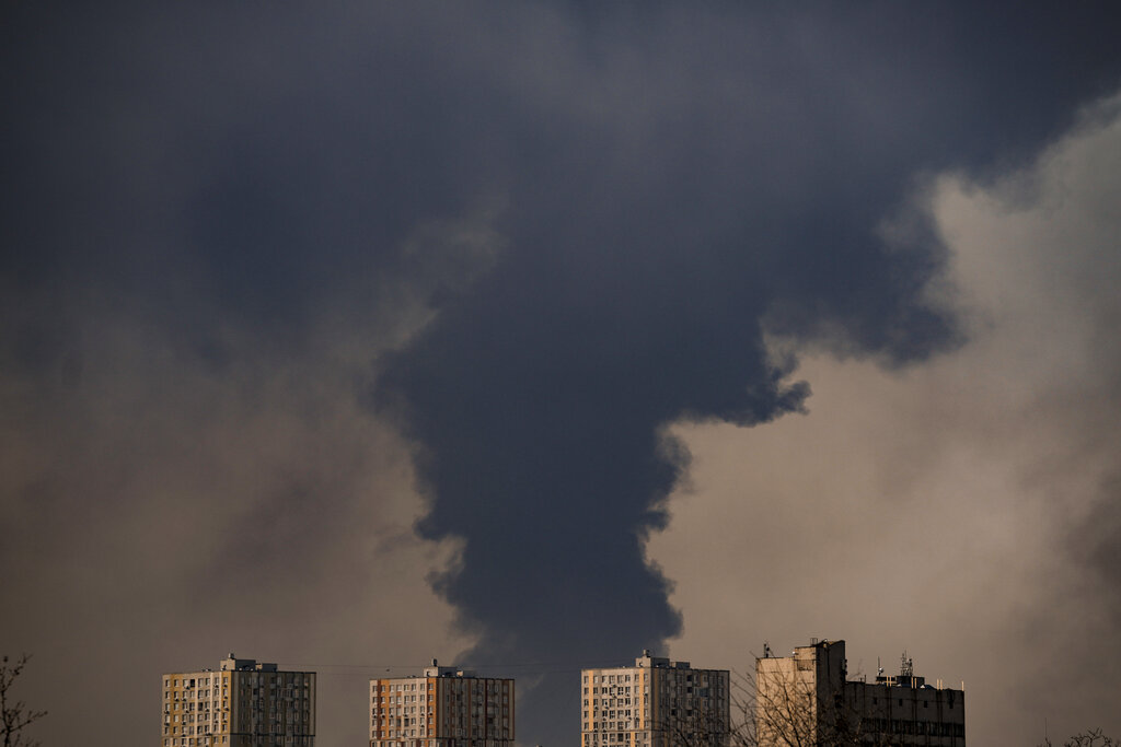 Heavy smoke billows after a Russian bombardment on the outskirts of Kyiv, Ukraine, Friday, March 25...