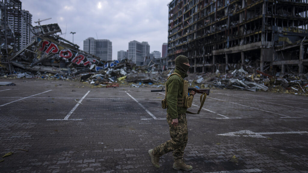 A soldier walks the amid the destruction caused after shelling of a shopping center last March 21 i...