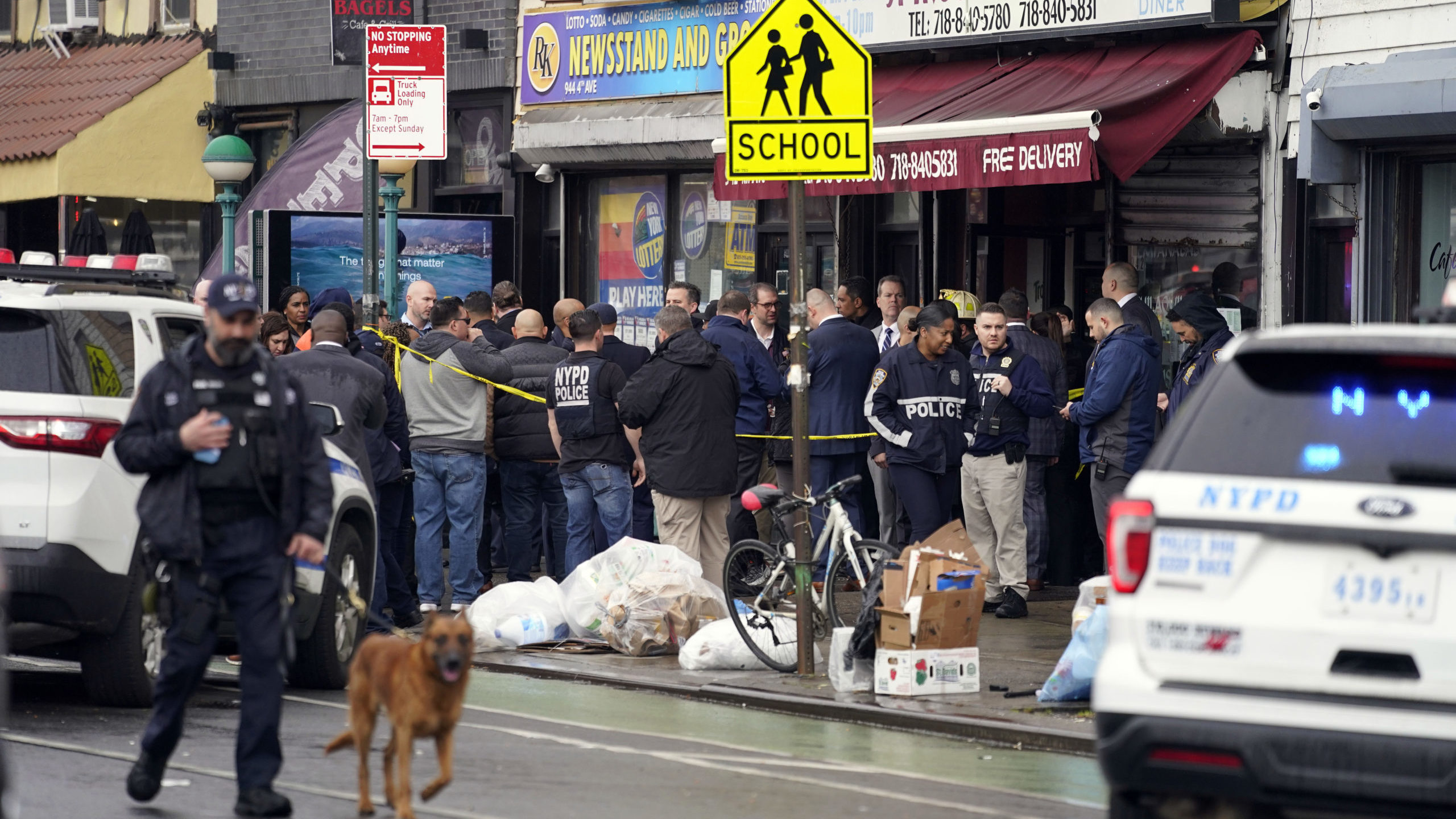 New York City Police Department personnel gather at the entrance to a subway stop in the Brooklyn b...