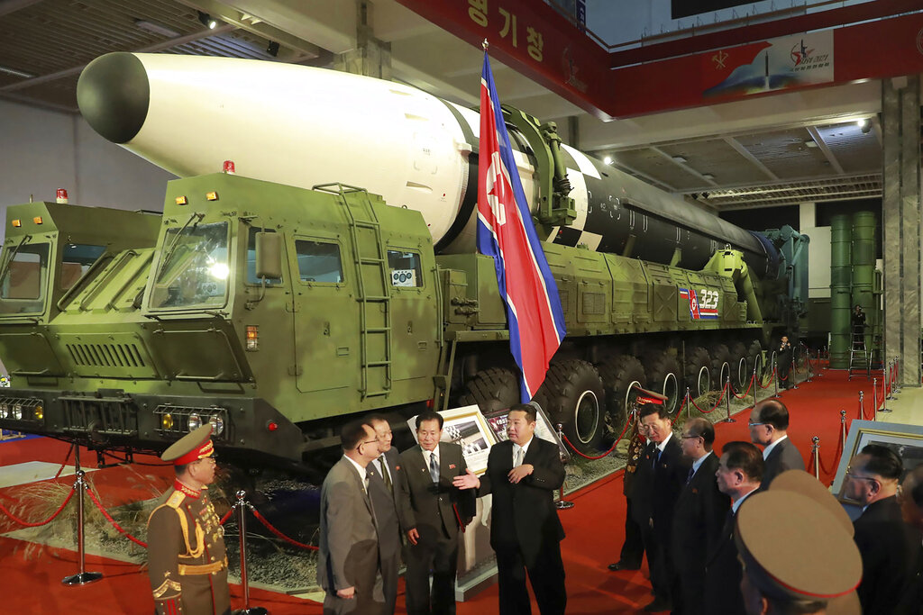 FILE - In this photo provided by the North Korean government, North Korean leader Kim Jong Un, cent...