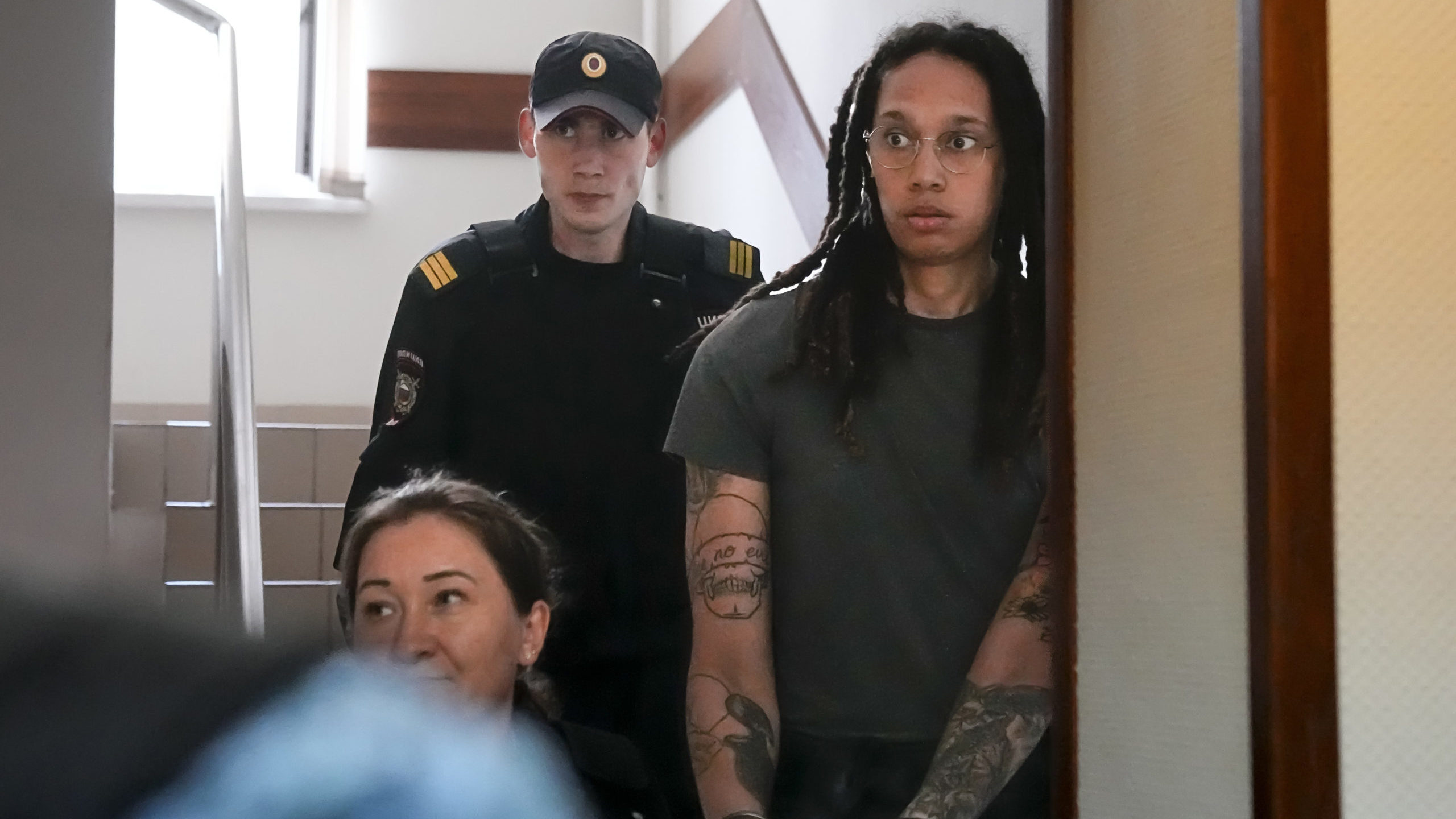 WNBA star and two-time Olympic gold medalist Brittney Griner is escorted to a courtroom for a heari...