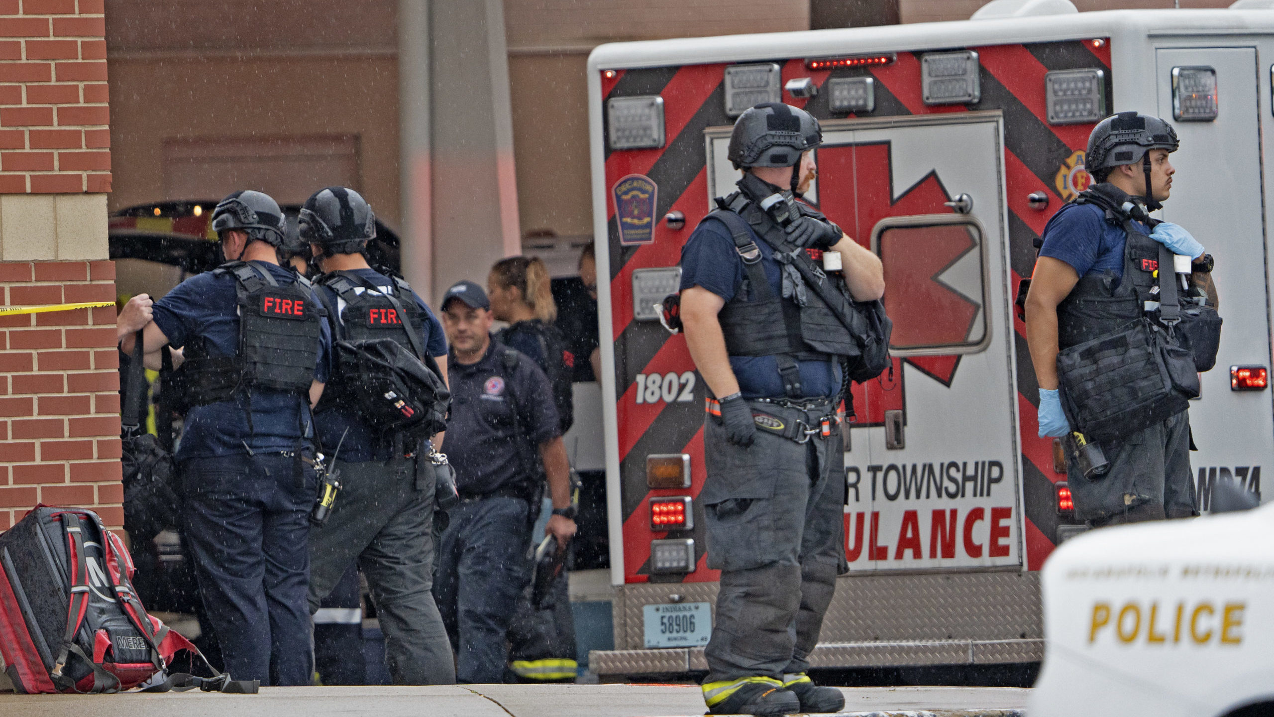 Law enforcement wait outside after a deadly shooting Sunday, July 17, 2022, at the Greenwood Park M...