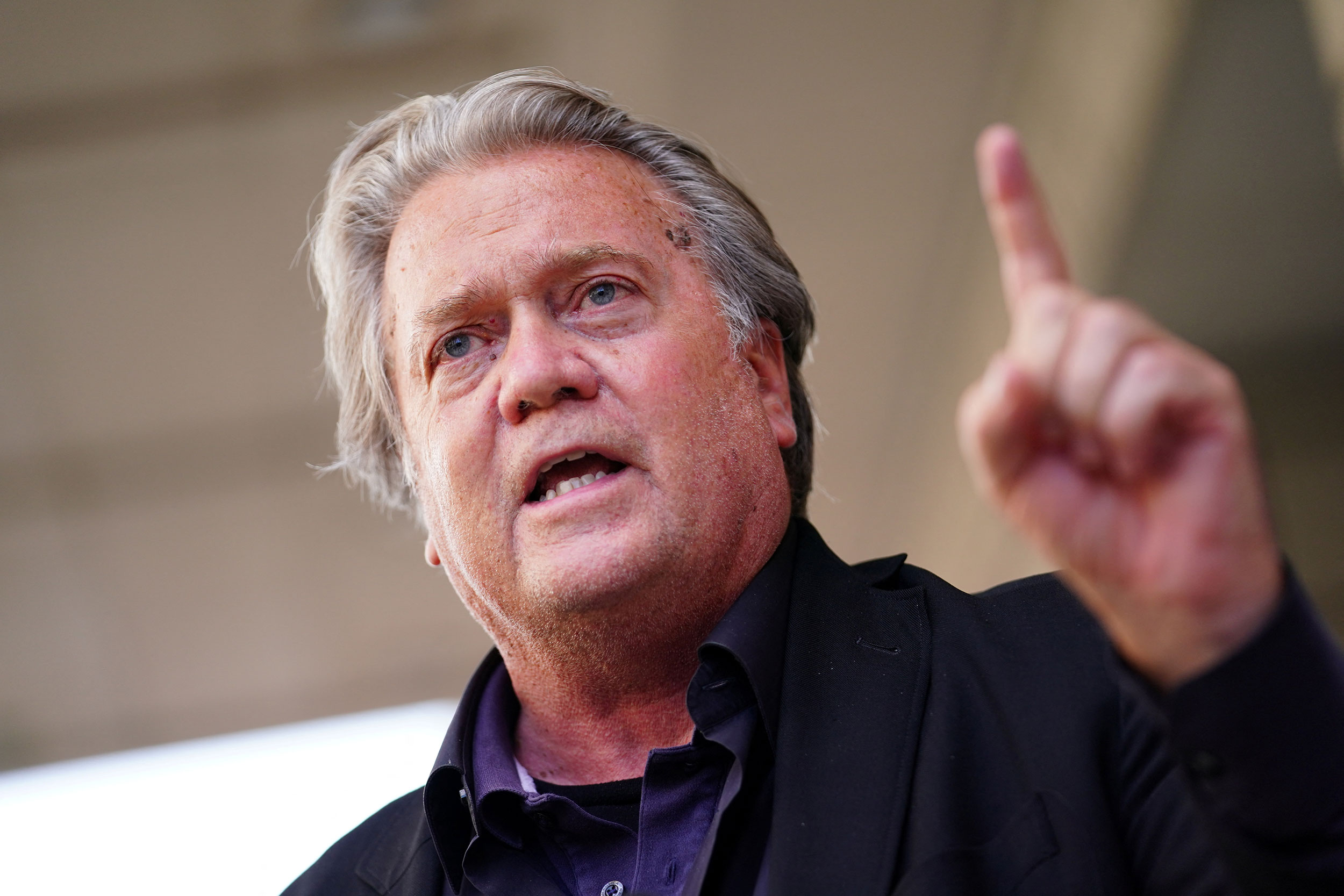 Former Trump White House chief strategist Steve Bannon speaks to members of the press as he departs...