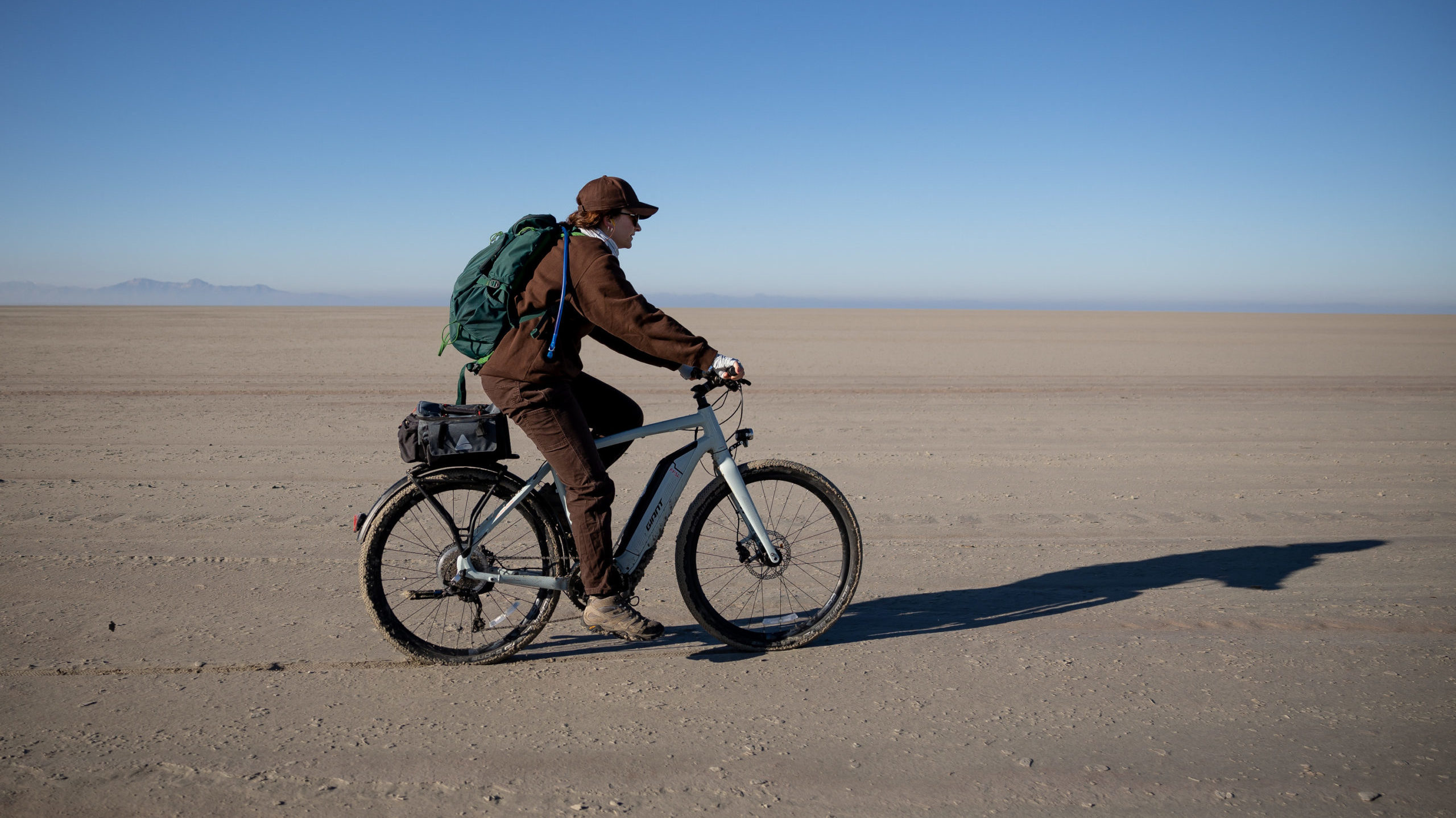 a woman rides her e-bike, e-bikes are now banned in certain wildlife areas in Utah...