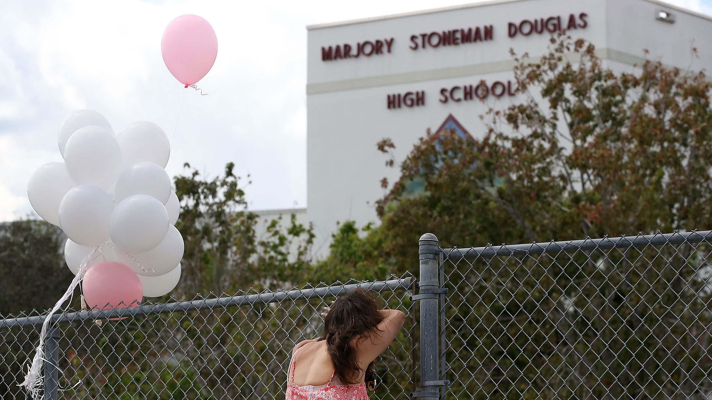 PARKLAND, FL - FEBRUARY 18: Angela Tanner, rests against the fence that surrounds the Marjory Stone...