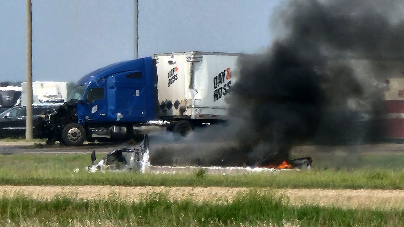 Smoke comes out of a car following a road accident that left 15 dead near Carberry, west of Winnipe...