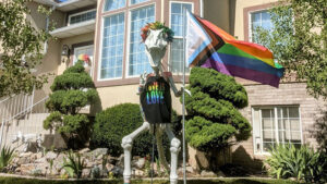 LINDON, UTAH – Vandals dismantled part of 9-foot-dinosaur decoration that has dotted a Lindon neighborhood for the past five years. Homeowner, Sara Dye, said it wasn’t the dinosaur the suspects were going after. “My pride flag was gone. The dinosaur was holding a pride flag, and that symbol of acceptance and the dinosaur’s arms were missing. The rest of the broken dino had been dragged into the middle of the street,” Dye said. “I was thinking to myself – it finally happened.” Dye decorated the skeleton dinosaur for all occasions. Denver, as neighbors fondly call the structure, has weathered the deep snow during Christmas, dressed as Cupid for Valentine’s Day, and even acted as a beacon of hope for a little boy named Rex who was fighting cancer, a few houses down. And in June, Dye gave Denver a rainbow vibe. “I am very excited about pride,” Dye said. “It was a large part of my life that I couldn’t talk about when I was younger, and now living in a very Mormon neighborhood – we do try to be very respectful.” After investigating, officers with the Lindon City Police Department found pieces of Denver and the pride flag near the Murdock Canal Trail. “It’s still an open investigation. We have officers canvassing the area, near the canal, searching for evidence,” Lindon City Police Chief Mike Brower said.