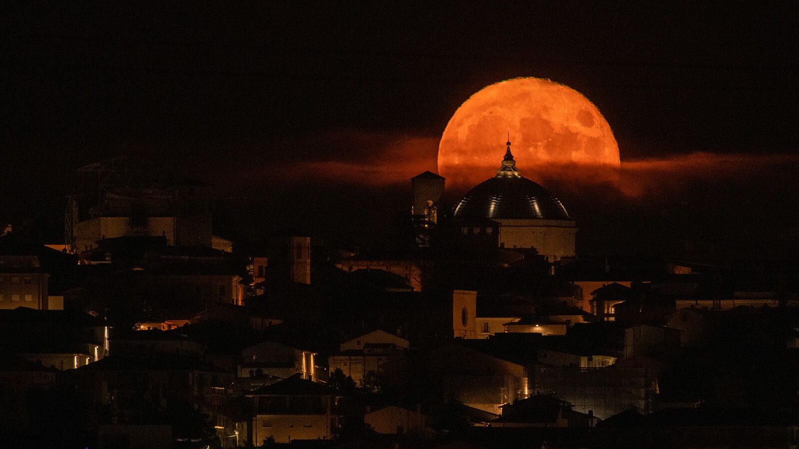 The sturgeon supermoon rises behind the Basilica of San Bernardino in L'Aquila in Italy's Abruzzo r...