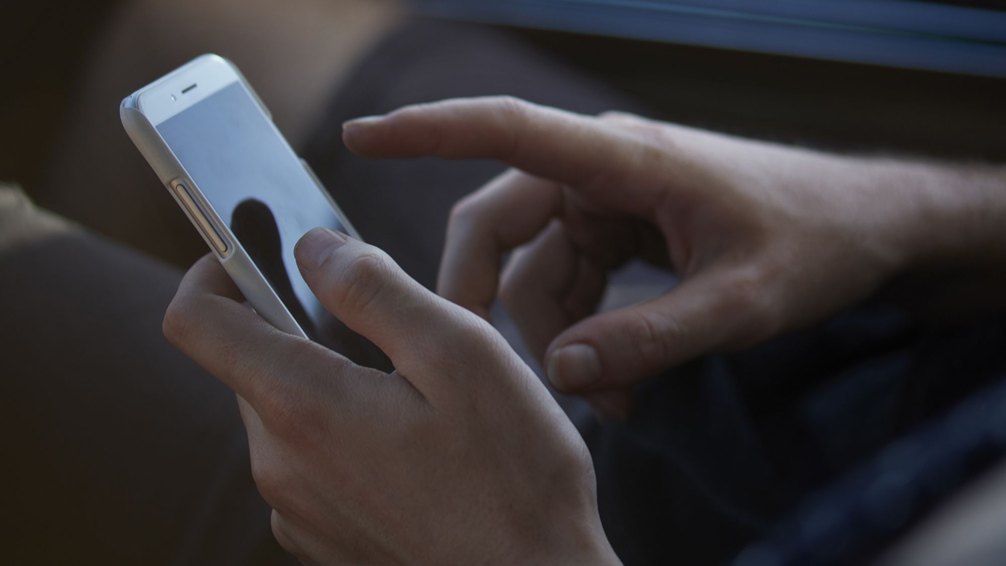 Image of somebody using a cell phone. The FCC imposed a record $300 million fine on a massive illeg...