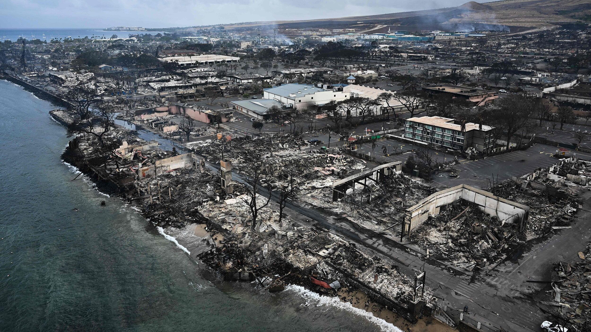 An aerial image taken on August 10 shows destroyed homes and buildings on the waterfront burned to ...