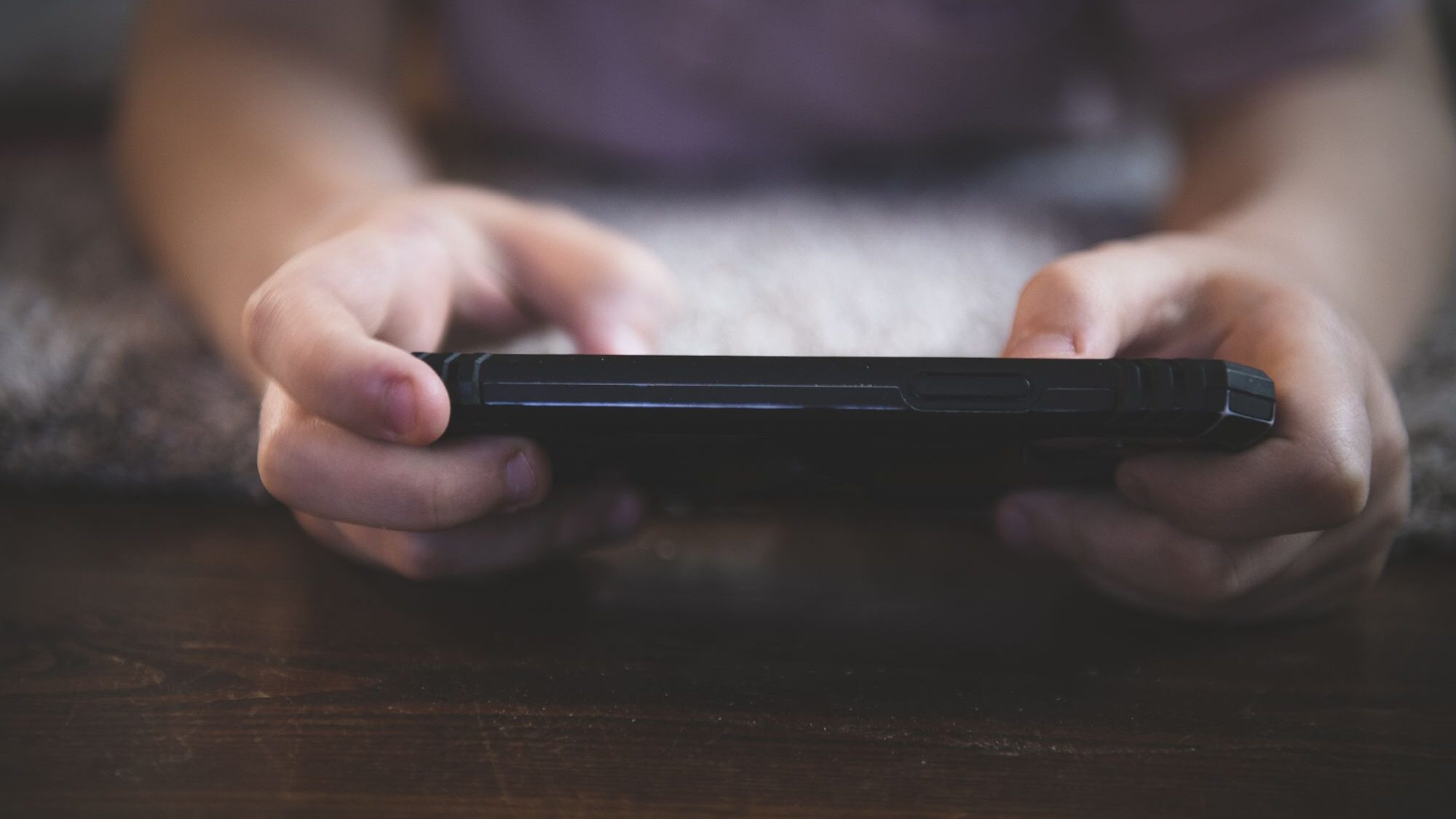 Image of a child holding a cell phone....