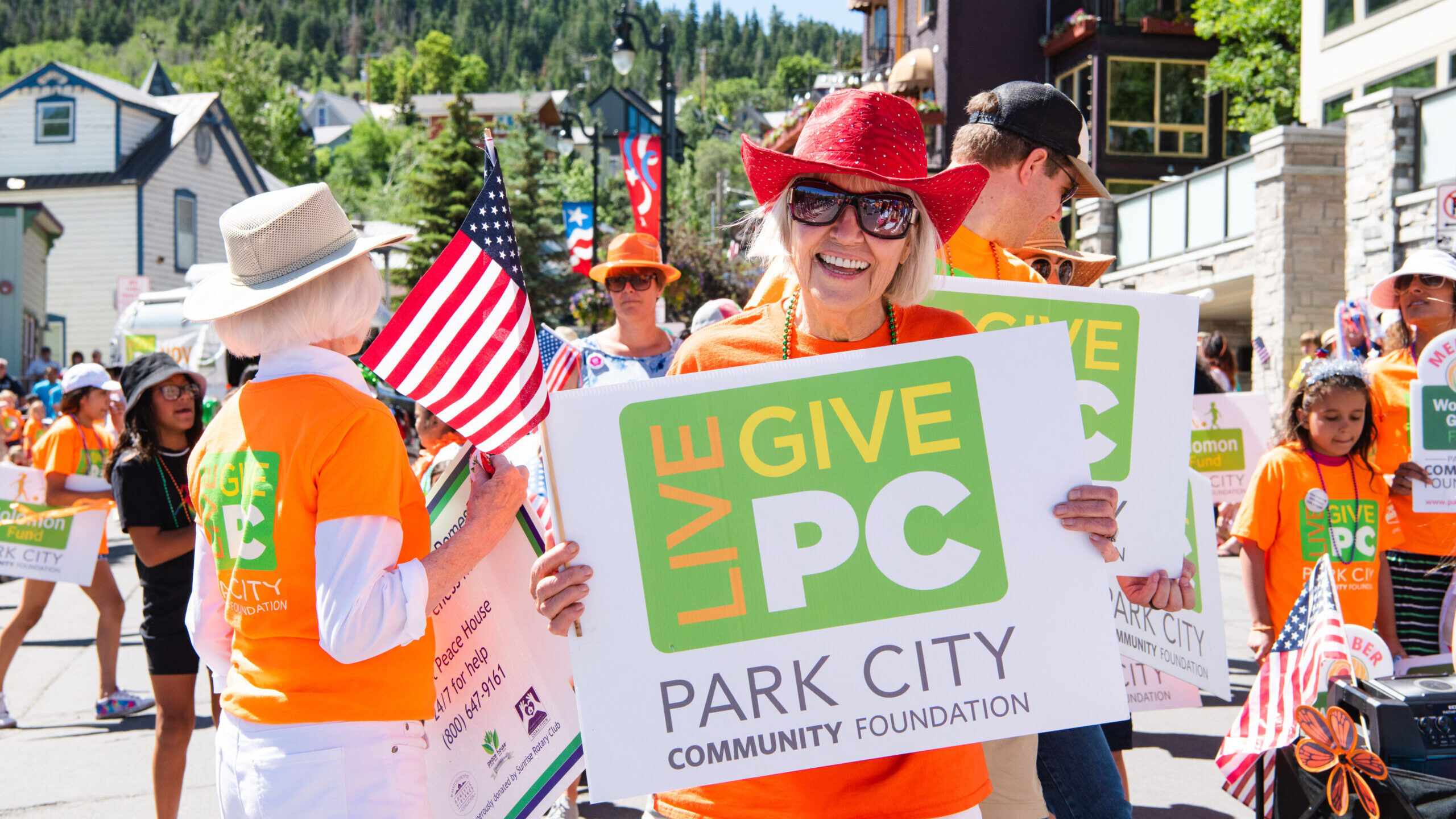 Volunteers hold signs during the 2022 Live PC Give PC fundraiser event....