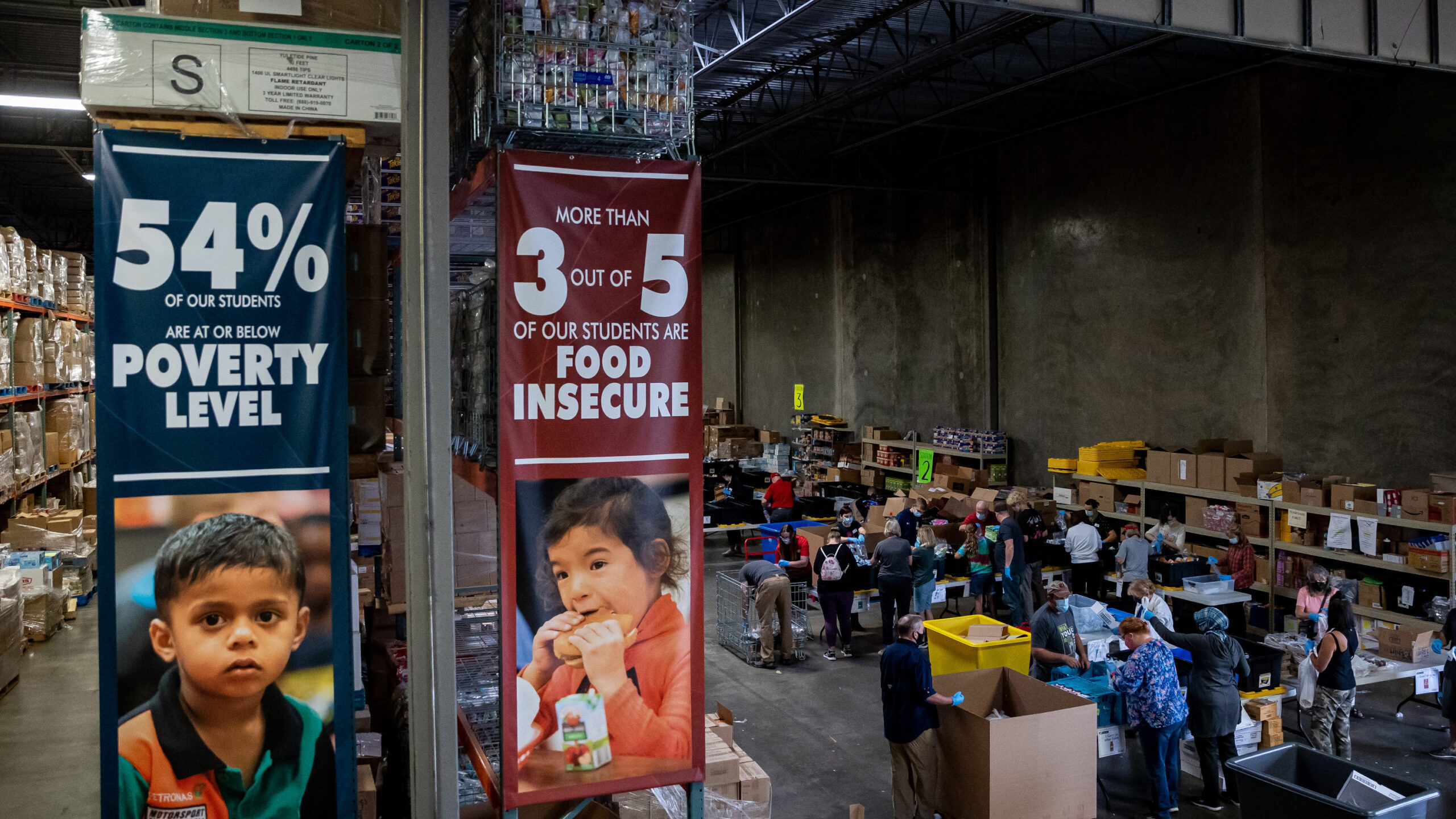 Volunteers assemble meal and snack kits at the Granite Education Foundation's donation and distribu...