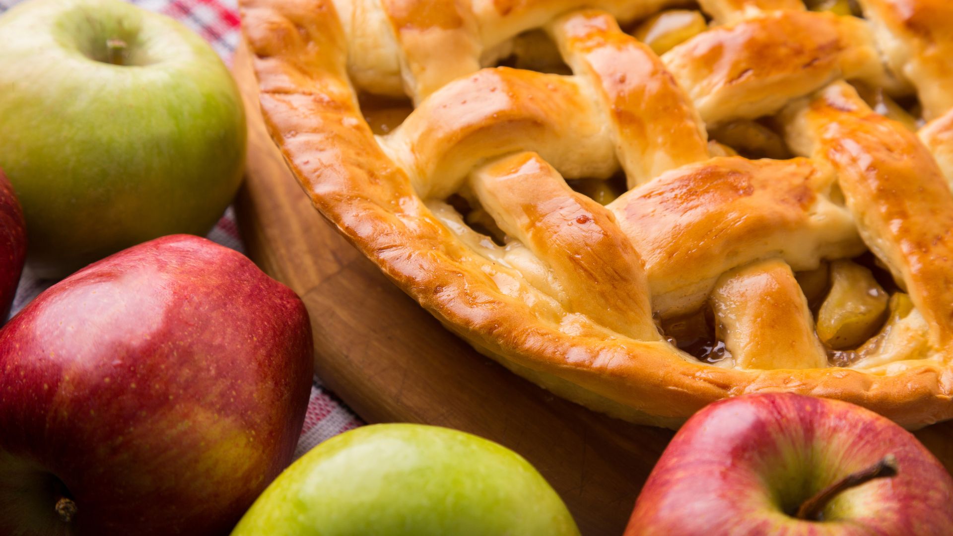 An apple pie surrounded by apples....