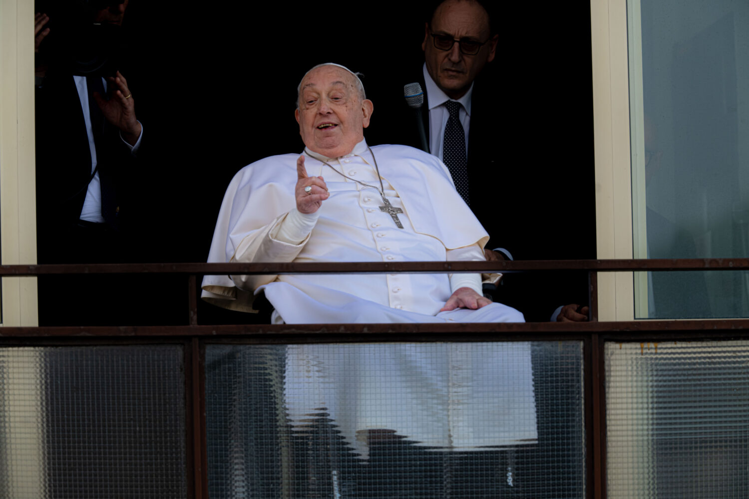 Pope Francis gestures as he appears at a window of the Agostino Gemelli Polyclinic in Rome, Sunday,...