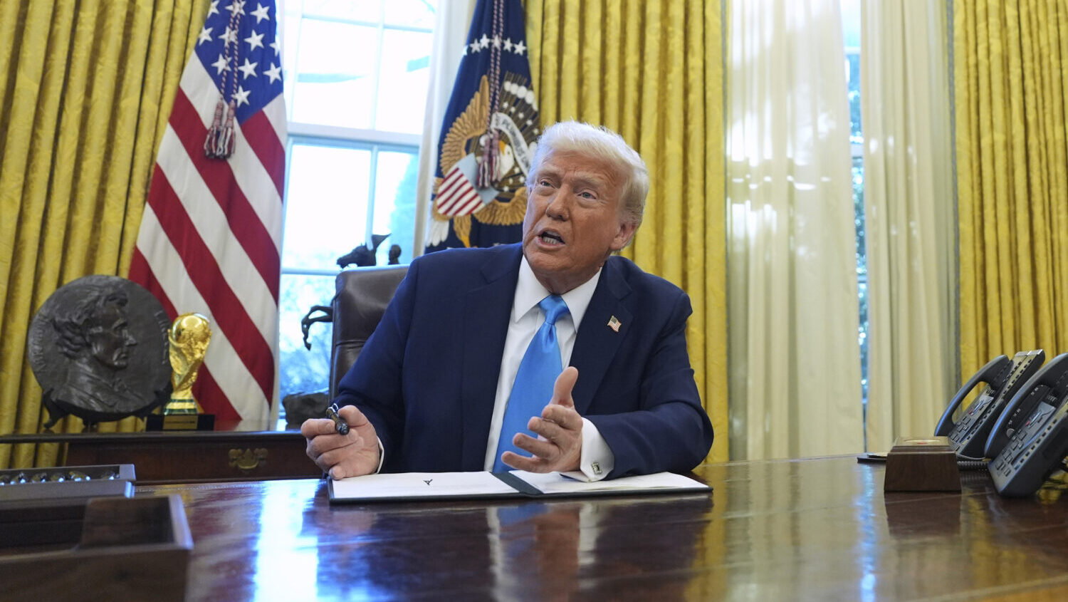 FILE - President Donald Trump speaks to reporters as he signs executive orders in the White House, ...