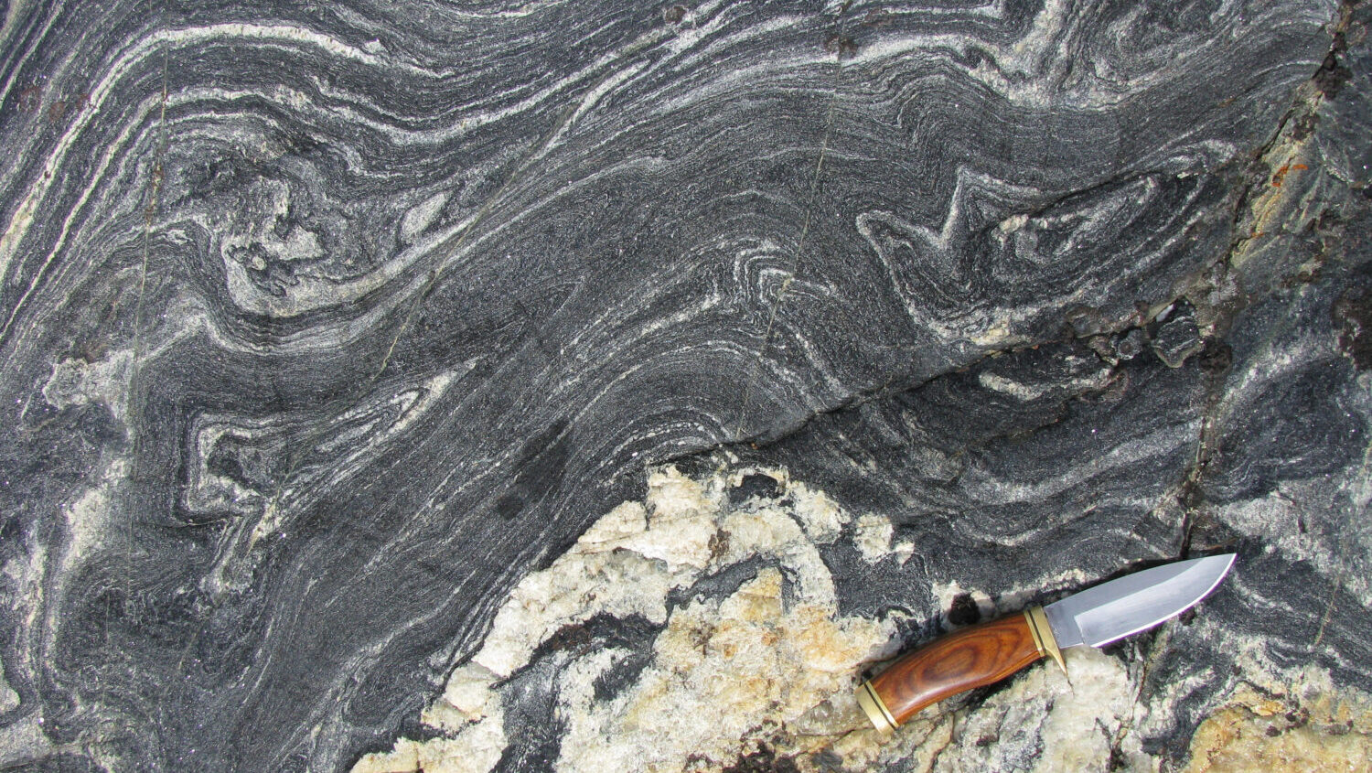 This photo provided by researcher Jonathan O'Neil shows an outcropping of about 4.16 billion year o...