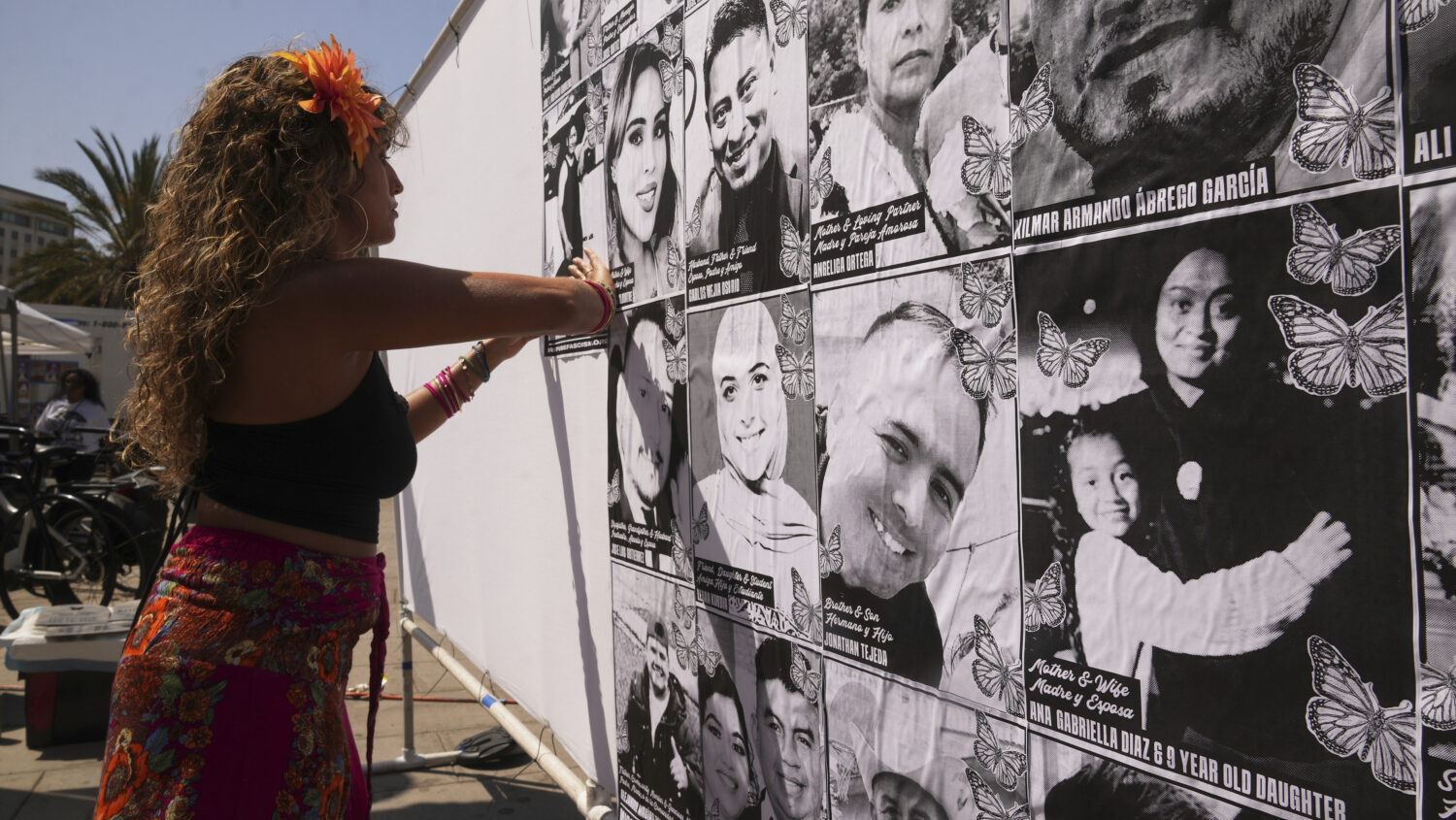 Special needs teacher Deja Nebula sets up an art installation displaying names and faces of people ...
