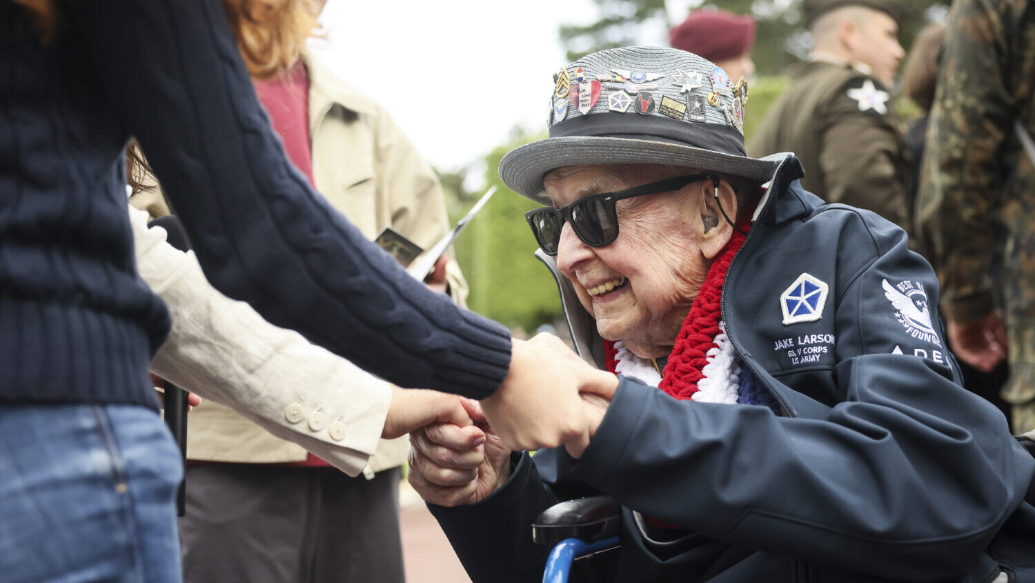 FILE - World War II veteran Jake Larson meets youths during ceremonies at the US cemetery to commem...