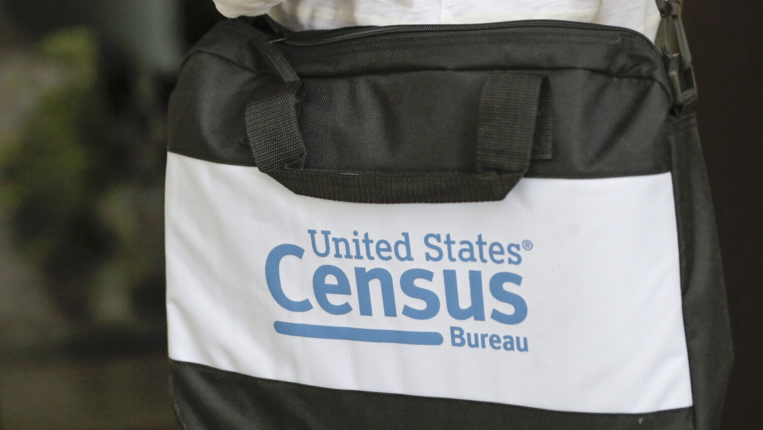 A briefcase of a census taker is seen as she knocks on the door of a residence, Aug. 11, 2020, in W...