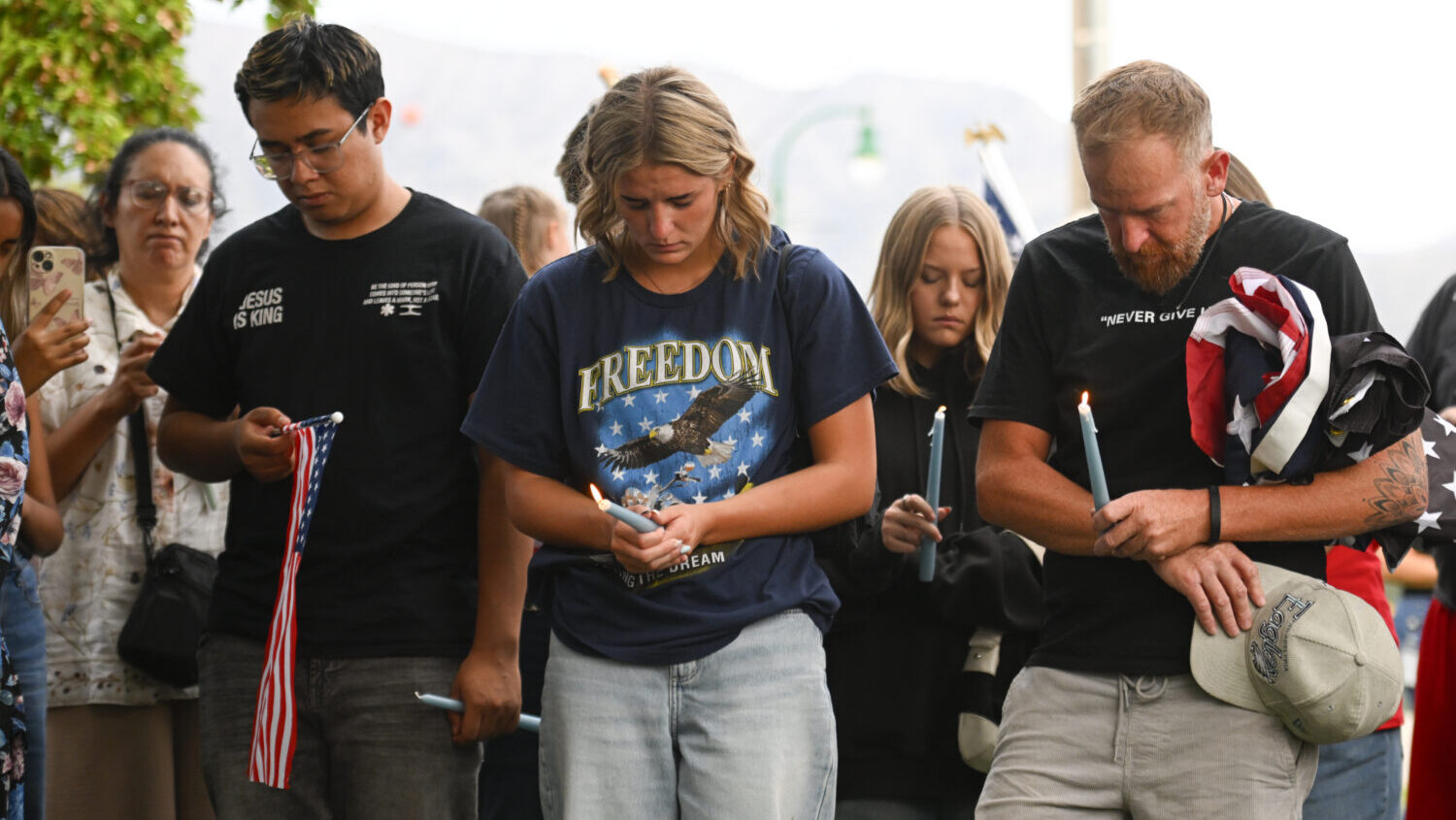 People attend a vigil at Timpanogos Regional Hospital for Charlie Kirk, the CEO and co-founder of T...