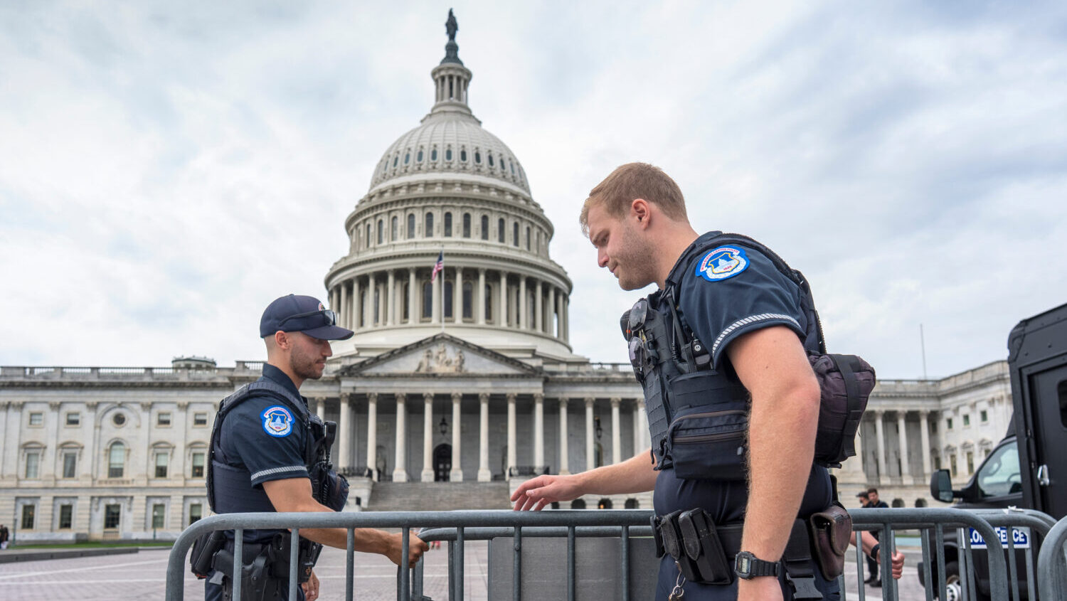 Capitol Police officers adjust security barriers around the East Plaza at the Capitol in Washington...