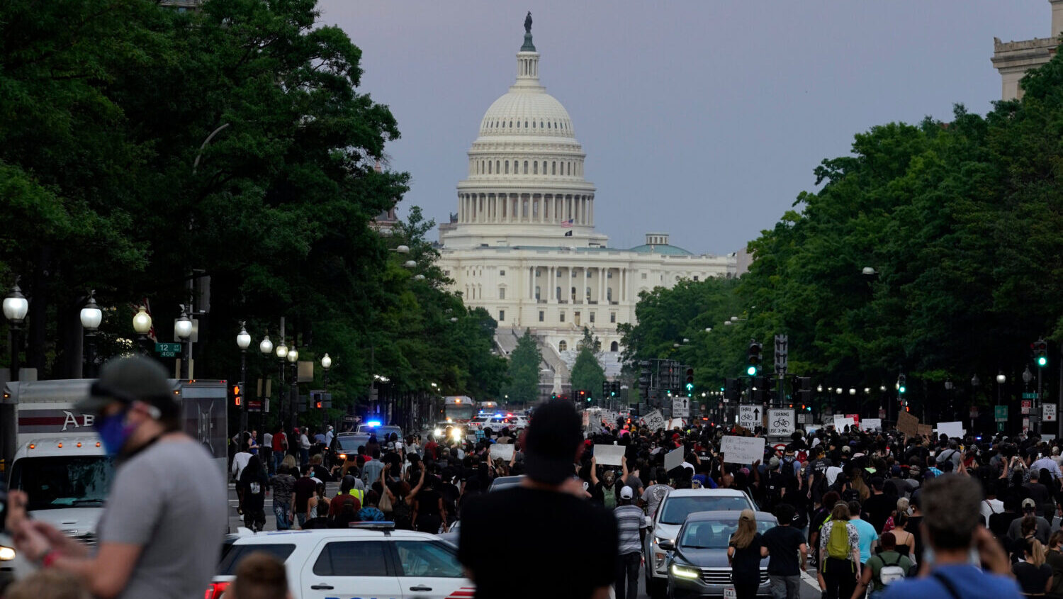 FILE - Demonstrators walk along Pennsylvania Avenue as they protest the death of George Floyd, May ...
