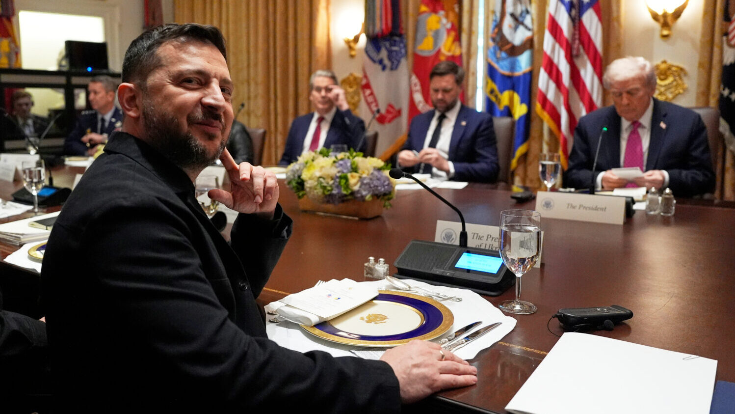 Ukraine's President Volodymyr Zelenskyy, left, sits before a meeting with President Donald Trump, f...