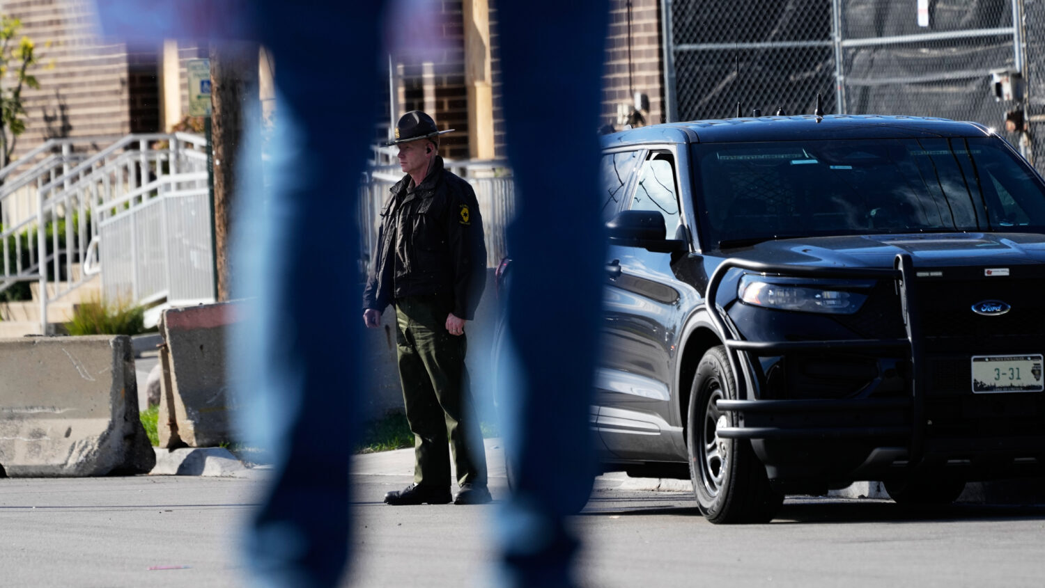 A Illinois State Police officer stands outside an ICE (U.S. Immigration and Customs Enforcement) pr...