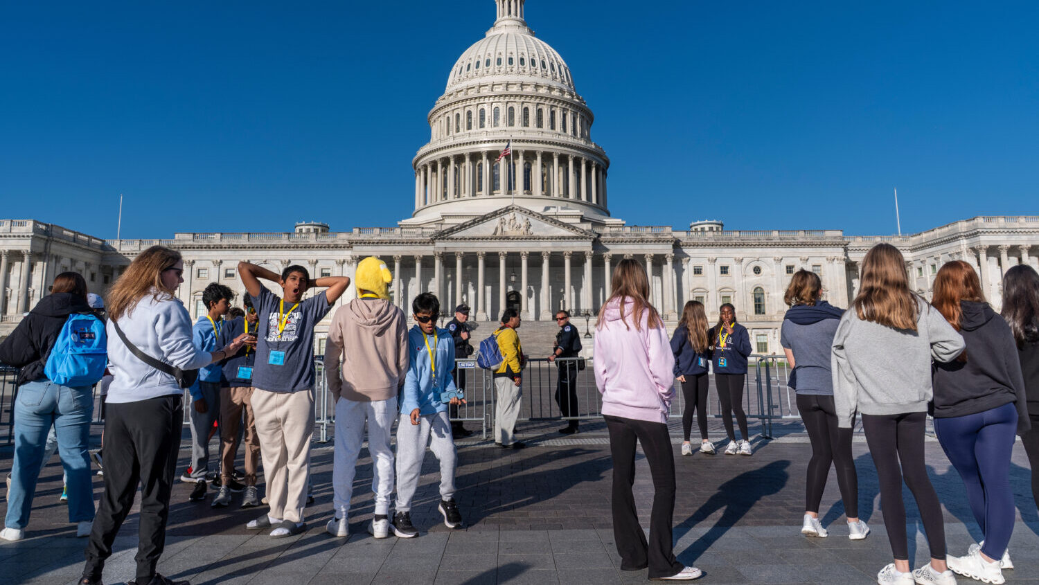 Students from Columbus, Ohio, wait outside a barrier as U.S. Capitol Police watch over the East Pla...